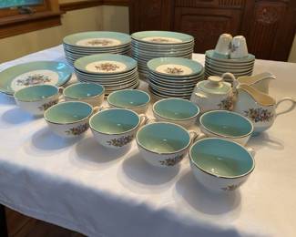 Large China Set with Turquoise Bands and Floral Center An extensive china service featuring a turquoise-blue band, delicate floral bouquet centers, and gold rim trim. The lot includes dinner plates, salad plates, bread plates, saucers, a full set of teacups with turquoise interiors, a creamer, and a salt and pepper set. The pieces present clean and bright in the photos with the gilt appearing intact, though individual pieces were not inspected for chips, crazing, or gold wear. The manufacturer's backstamp was not photographed and should be checked before listing.
