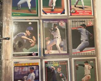 Nolan Ryan and Roger Clemens Card Binder Page A binder page featuring Nolan Ryan and Roger Clemens cards, including a Rangers Opening Night Pitcher card, two Roger Clemens Red Sox cards from Donruss and Fleer, a Fleer Players of the Decade card, and an All-Star card. Cards are sleeved in a nine-pocket sheet with light handling wear. Two of the most recognizable arms of the era in one page.