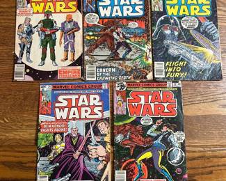 Marvel Star Wars Comic Lot — Five Issues Including #42 Five Marvel Star Wars comics, including issue #42 with the Boba Fett cover and the Empire Strikes Back banner, a Darth Vader "Flight Into Fury" cover, and a "Cavern of the Crawling Death" cover. All five are bagged. The covers show creasing, spine wear, and edge wear throughout — these are reader-grade copies, not high-grade. Issue #42 is the first comic appearance of Boba Fett and drives the value of this lot.