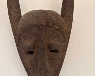 $300 West African carved wood mask with antlers. Mid-20th century