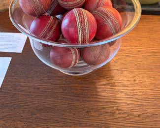 Antique cricket balls in a Simon Pearce bowl sold separately during in person shopping hours.
