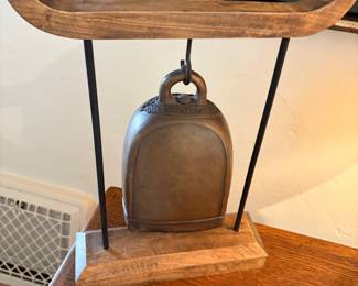 Antique yak bell on stand for sale during in-person shopping hours