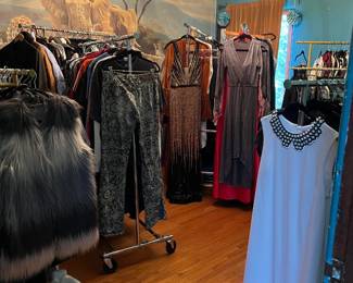 Multiple racks of fine clothing can be seen here in this photo.