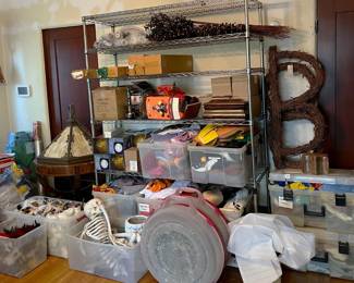 Yet another rack of shelves is here, showing some holiday decorations, including two wreath containers, a Halloween skeleton, an inflatable Thanksgiving turkey, and much more.