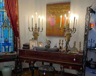 Moving inside, you can see not only the artwork hanging on the wall, but the candleabra-style lamps, the table, and three duck decoys.