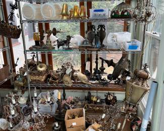 On these shelves are a mix of different decorative lamps and sconces.  
