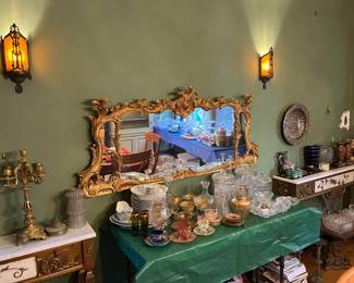 Between the matching tables is this ornate wall mirror, and the decorative serving dishes on the green table.  You'll want to see these items.