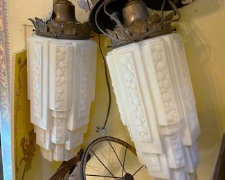 I think these are a pair of hanging lamps.  To me they look like upside-down cityscape lamps.