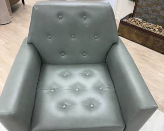 Leather arm chair with gold accent legs