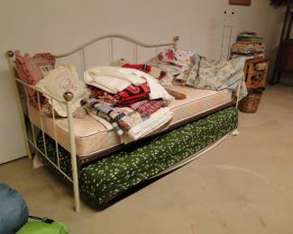 Daybed, with various shades of things on it