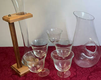 Lot 30: Glassware set with tall decanter on wooden stand, pitcher, and stemmed glasses