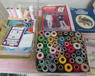 Crafting supplies and instruction booklets for hand embroidery projects