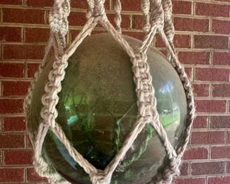 Macrame plant holder and a green glass float