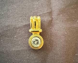 Gold tone pendant with jewel