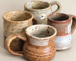 Assorted speckled pottery mugs. We prefer to sell as a four piece set.