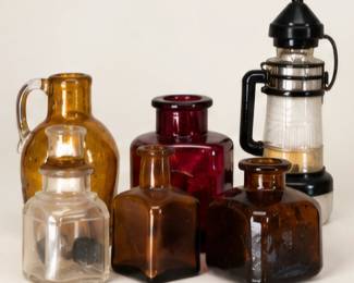 Assorted vintage glass bottles and lantern. All items are sold separately.