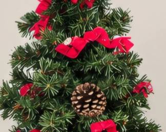 Tabletop Christmas tree with red ribbon