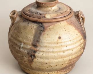 Tan lidded pottery jar