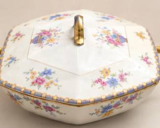 Vintage floral porcelain covered serving dish with gold-tone handles and trim. Features a colorful scattered-flower pattern and faceted lid.