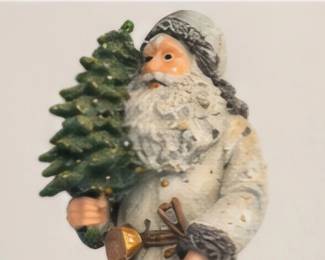 Woodland Santa holding a Christmas tree