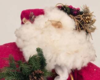 Large plush Santa with Christmas greenery