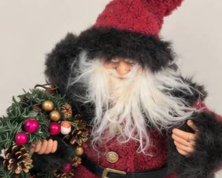 Plush Santa holding a Christmas wreath