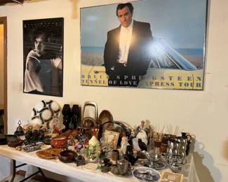 Bruce Springsteen poster and table full of ornamental and decorative pieces