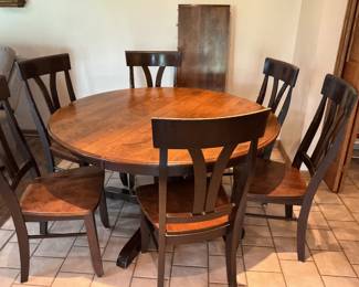 Dinner room table with six chairs and one leaf.  Table measures 54” round and one leaf 18”. Presale is $250
