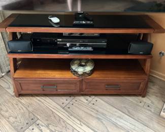 TV stand measures 26.5 h x 18” h x 52”w.  Has 3 shelves and two drawers