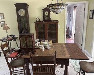C. 1900 tall clock  1900 shelf clock     table with spool legs     oak drop leaf table    Set of 4 oak chairs