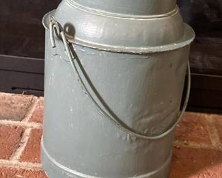 050 vintagemetalpaintedmilkcanwithhand