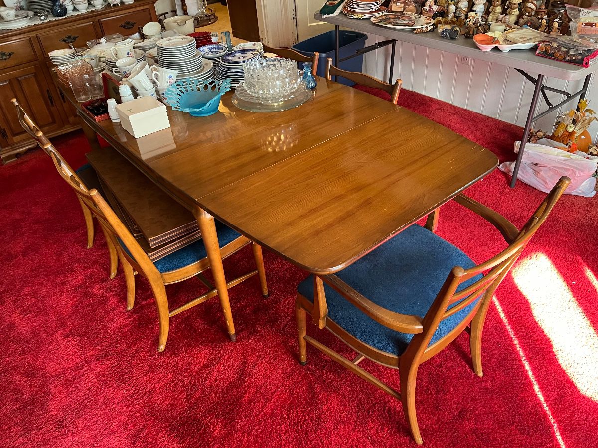 Mid-Century Modern dining table with six chairs and four leaves.