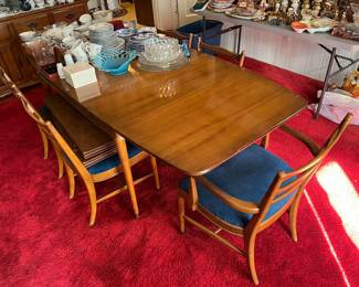 Mid-Century Modern dining table with six chairs and four leaves.