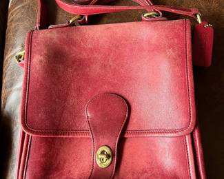 Red leather Coach station bag.