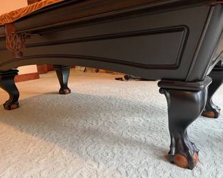 Closer view of the legs and feet on the Brunswick pool table.