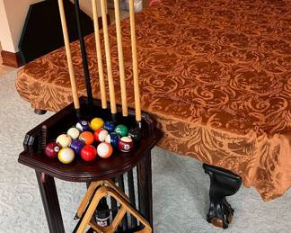 Pool balls, cues, and accessories to accompany the Brunswick pool table.