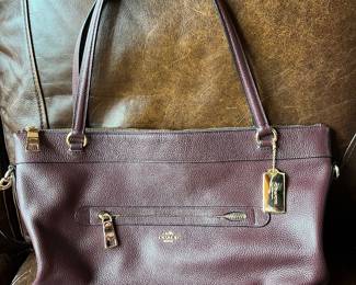 Dark burgundy or oxblood pebbled leather Coach shoulder bag.