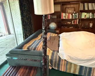 Heavily carved African floor lamp