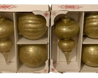 643 - 2 Boxes of Gold Colored Jumbo Ornaments (Description): - Members Mark - Round -approximately 8" Finial Ornaments - 14.5"