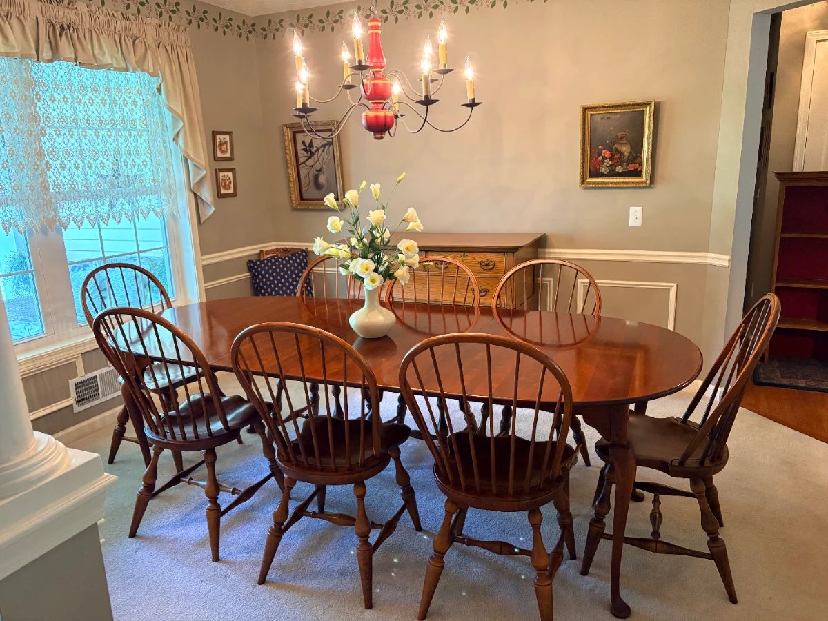 Cherry dining room table (set up with leaves in) with 8 bentwood style chairs.