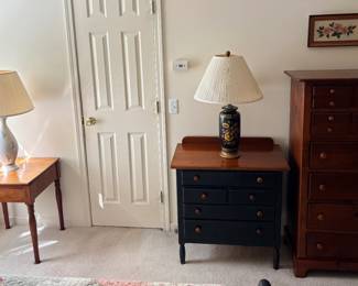 Nightstand, two of many lamps, one of many dressers, one of several end tables.
