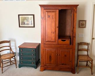 two of many caned chairs, TV armoire, nightstand. Two of many wall hangings.