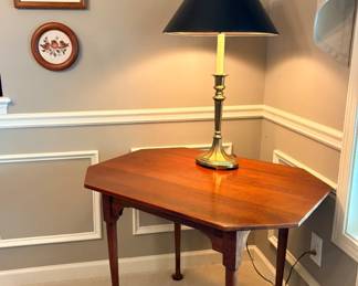 Cherry sidetable with theorem paintings in the background.