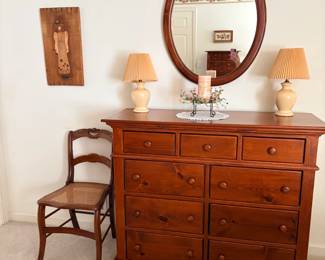 One of many dressers, 2 of many lamps, one of many mirrors. One of several roseback chairs.