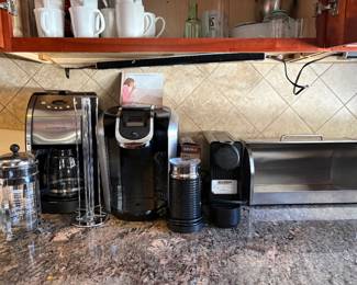 Coffee Makers & Coffee Accessories  A selection of coffee makers and accessories, including Cuisinart and Keurig coffee machines, a compact single-serve espresso/coffee maker, French press, electric milk frother, capsule holder and other coffee accessories.  A great assortment for coffee lovers, with several brewing styles and convenient countertop accessories.  Coffee machines and accessories are sold individually.  Please message for additional photos, model information, condition details or pricing. ☕✨
