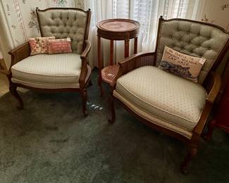 Pair of button-tufted chairs with caned side panels