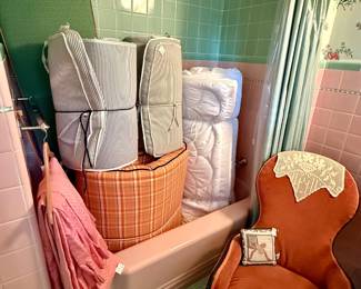 Sweet burnt orange chair and assorted covered cushions
