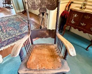 Antique press-back rocking chair with leather seat