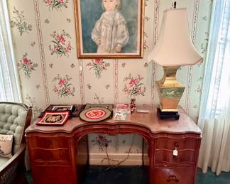 Pretty desk beneath framed art print of Renoir’s “Lucie Berard