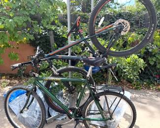Cannondale + Scott mountain bikes; standing metal bike rack (for 2 bikes)